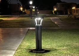 Solar bollard lights on community center campus lawn at night